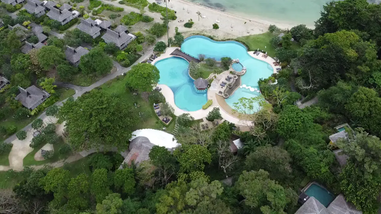 A tropical resort pool beside the beach — the asset classes the product catalog covers