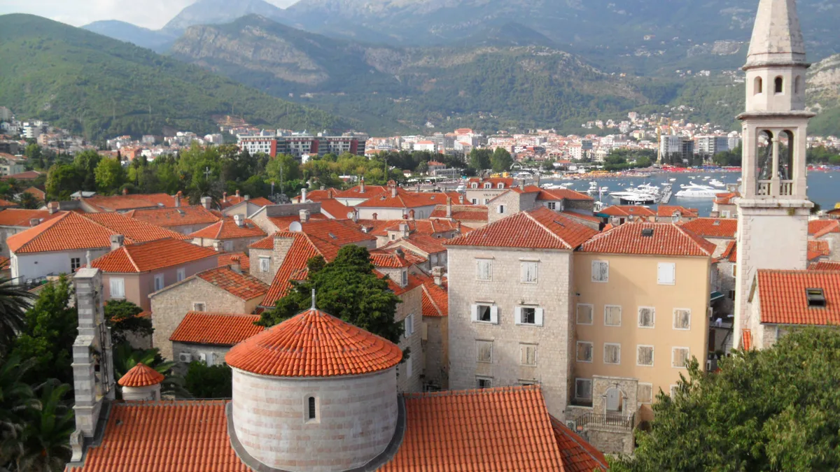 Budva old town rooftops: homes are open to foreign buyers, restricted land types are listed by law