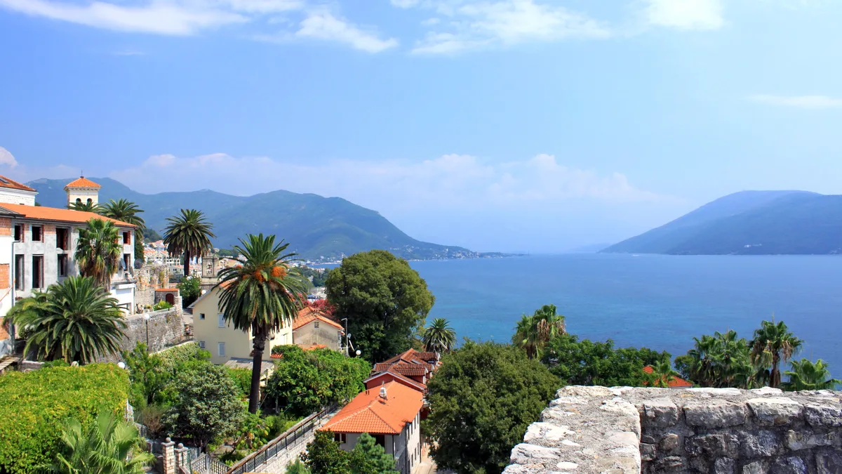 Herceg Novi houses above the bay: banded transfer tax on a resale, VAT on a new build