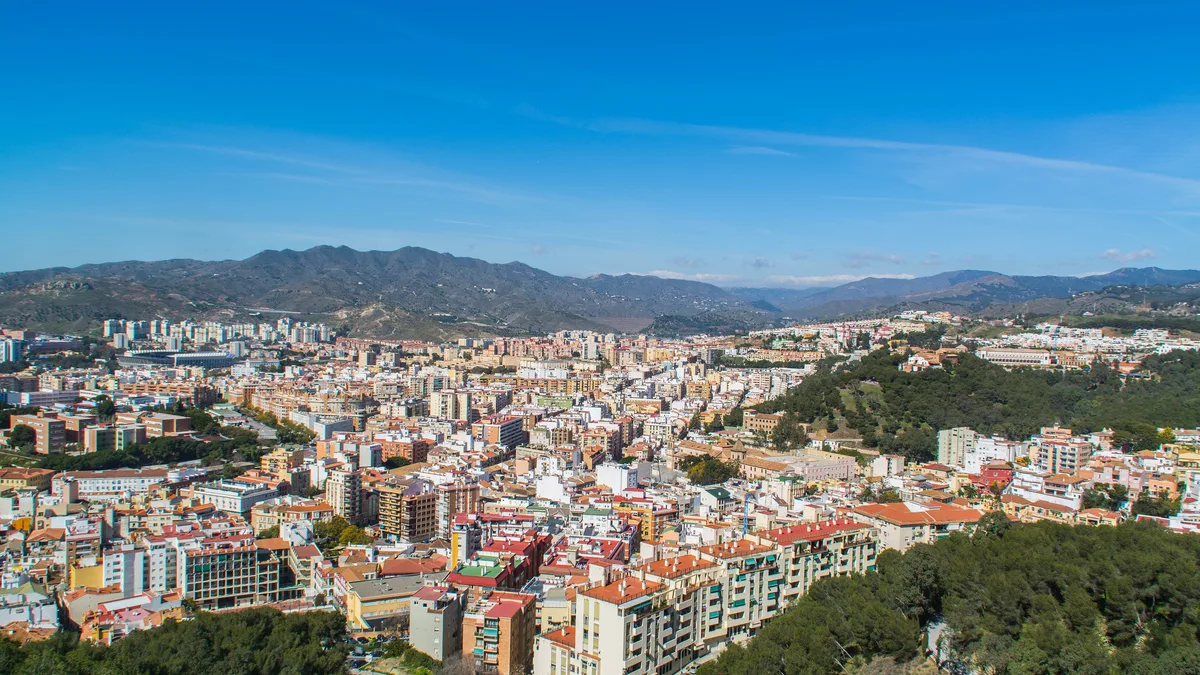Málaga's apartment districts seen from Gibralfaro, where every purchase starts with an NIE and a Registry check