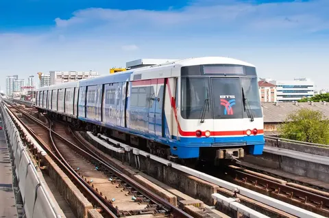 A BTS Skytrain on the elevated tracks at On Nut — the lower-Sukhumvit value corridor of the Bangkok condo market