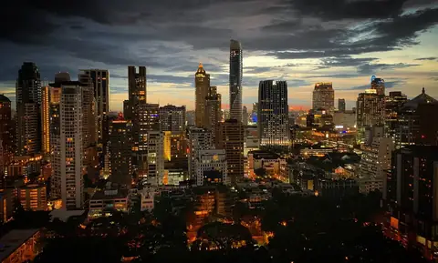 Bangkok at dusk — the capital side of the Chiang Mai vs Bangkok investment case