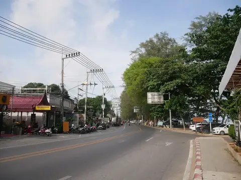 The Rawai beachfront road toward Nai Harn — the long-stay south where retirees and remote workers anchor rental demand