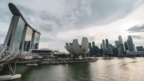 A city skyline at night — the two-country tax framework for property bought abroad