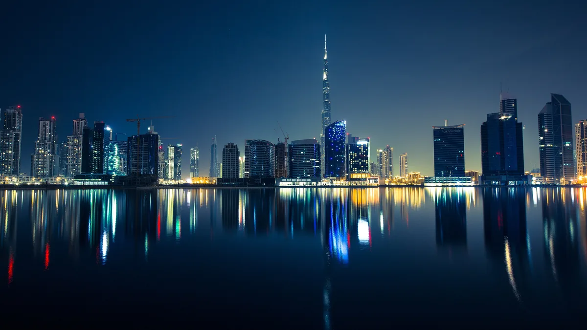 Dubai skyline with the Burj Khalifa reflected at dusk: no personal income or capital gains tax